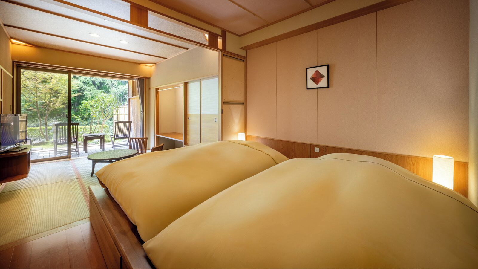 A room with two beds, a TV, and a view of a garden.