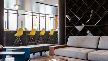 A modern lounge area with a sofa, chairs, and a coffee table.
