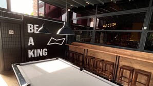 A pool table with a bar area and stools, a ceiling with exposed beams, and a sign that reads "BE A KING". - Yelken Hotel Akyaka (Ula)