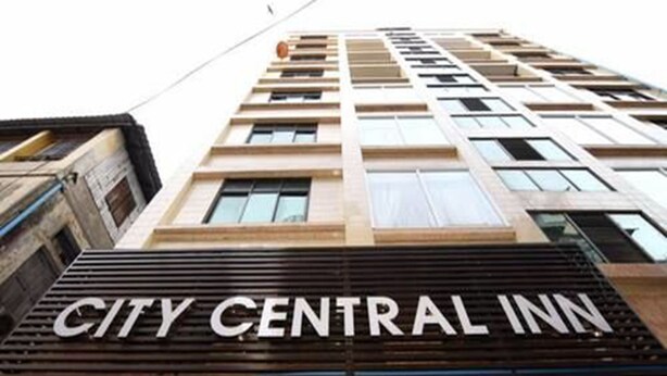 Fachada del edificio del City Central Inn, con un letrero llamativo.