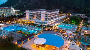 A resort with multiple swimming pools, a large covered area, and a variety of outdoor seating areas. - Dosinia Luxury Resort  (Kemer)