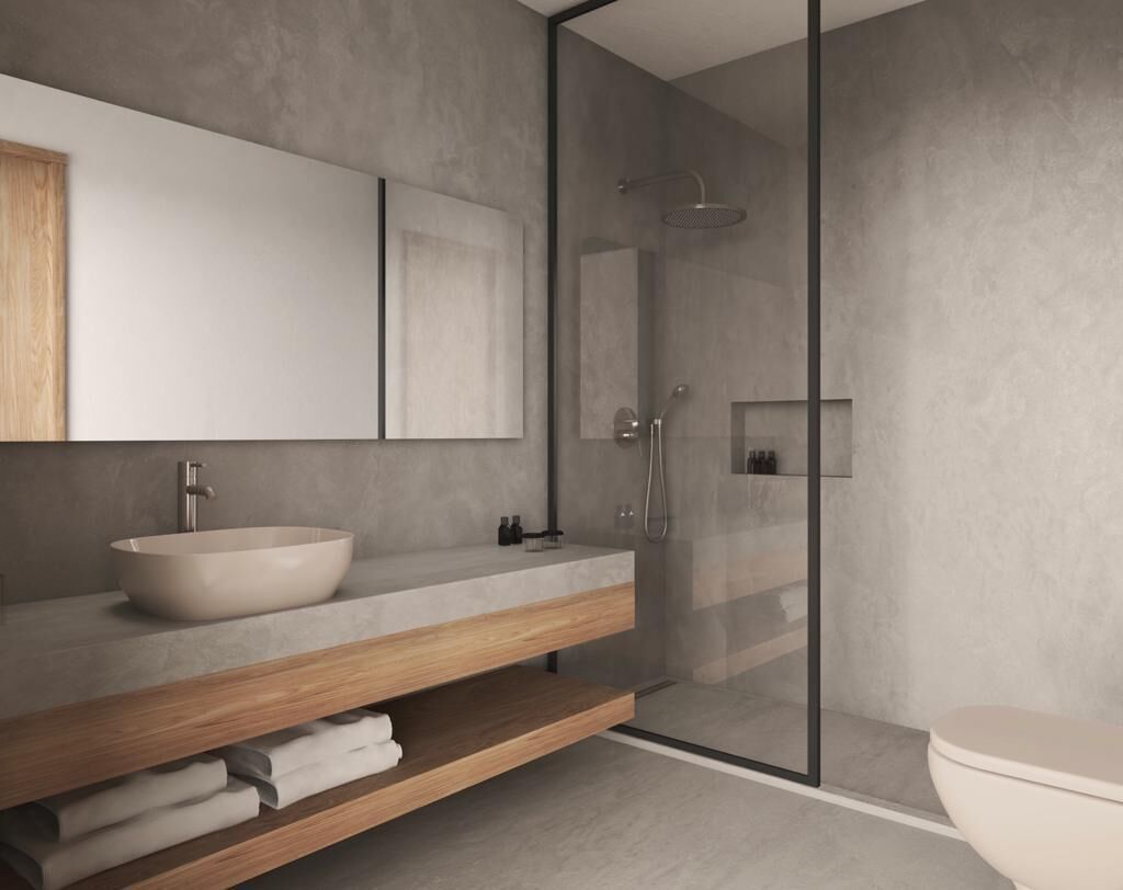 A modern bathroom with a large sink, a wooden vanity, a glass shower enclosure, and a toilet.