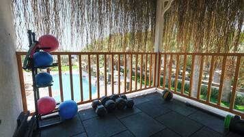 Enjoy a refreshing view of the pool and garden from this balcony.