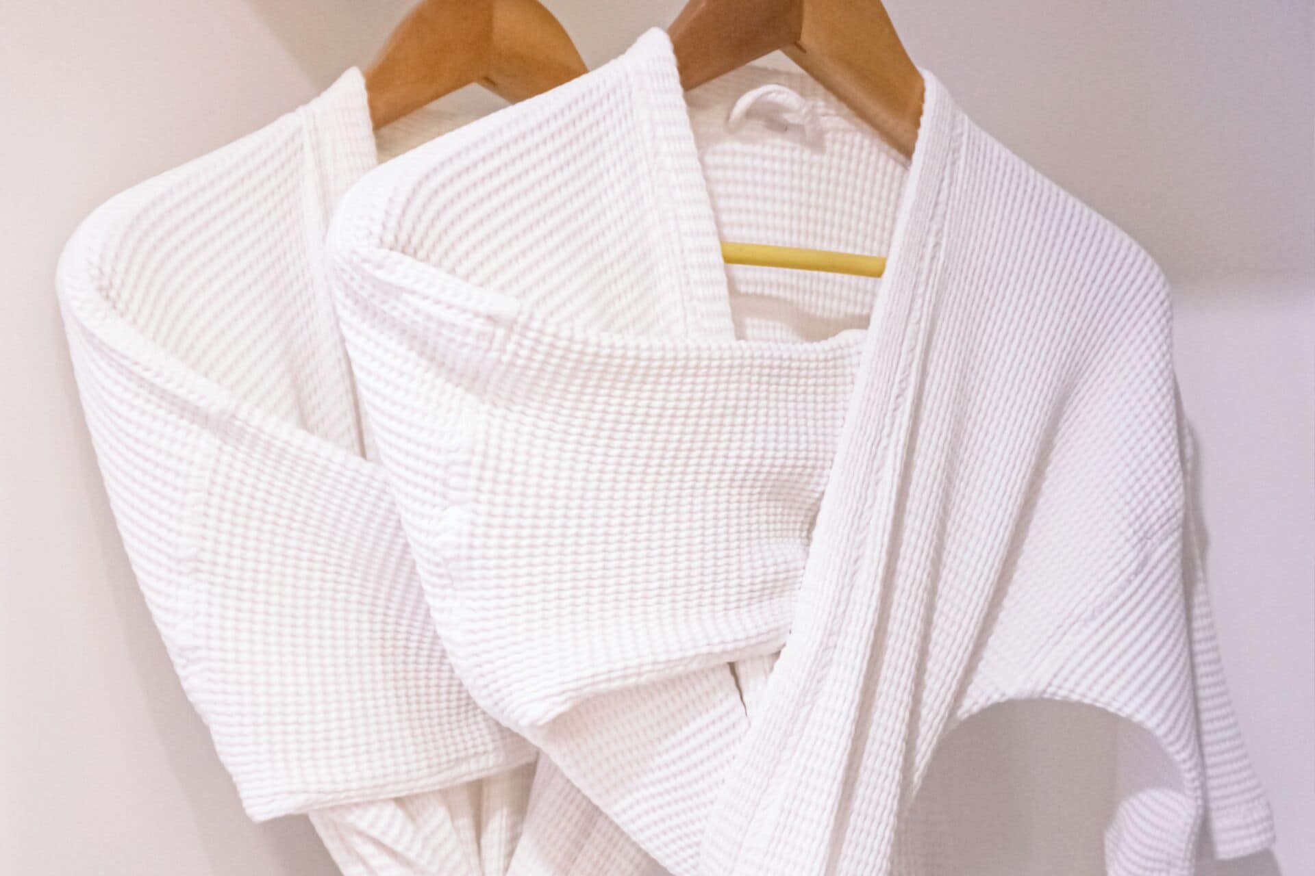 A white garment on a wooden hanger.