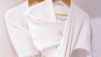 A white garment on a wooden hanger.