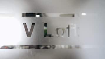 A frosted glass sign with the text "V Loft".