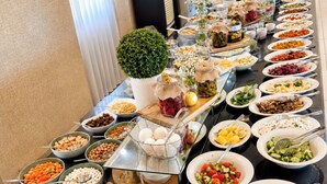 A buffet table with a variety of food options, including fruits, vegetables, and condiments. - Laodikya Otel (Denizli)