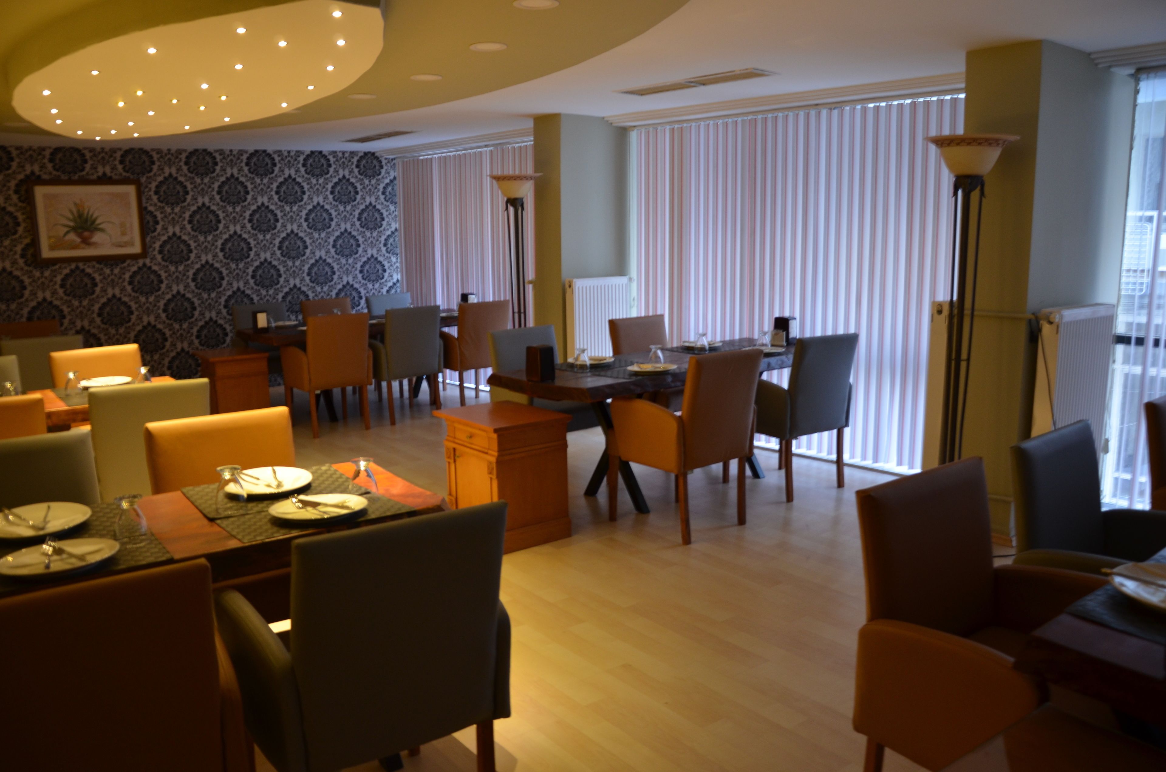 A dining area with a long table set for a meal, surrounded by chairs.