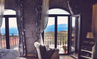 Junior Suite, Sea View | Premium bedding, minibar, in-room safe, travel crib