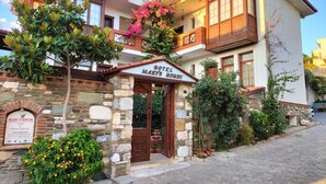 A two-story building with a stone facade, a balcony with wooden railings, and a sign reading "Hotel Mary's House." - Hotel Mary's House (Selçuk)