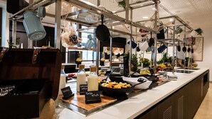 A buffet area with various food items and utensils displayed on shelves.