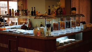 A buffet counter with various food items, beverages, and condiments. - Hotel Eken Prestige (Bandirma)