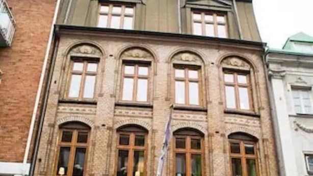 A multi-story building with a classic architectural style, featuring arched windows and a symmetrical facade. - H5 Hotel (Helsingborg)