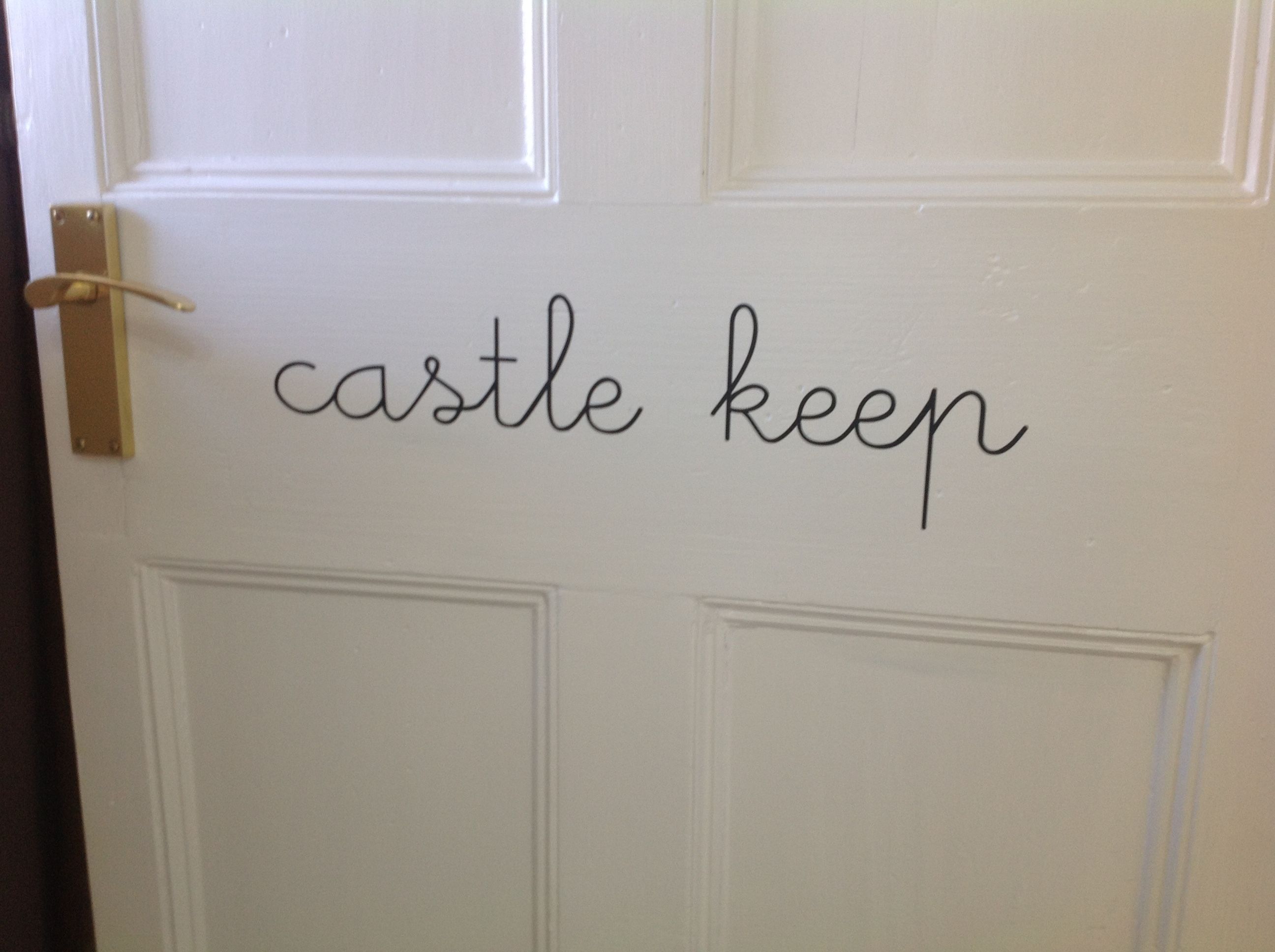 A white door with the words "castle keep" written on it.