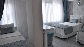 Standard Triple Room | Minibar, in-room safe, desk, iron/ironing board