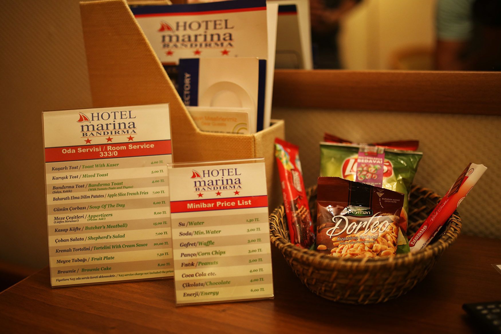 A hotel service menu and a price list for snacks and beverages.