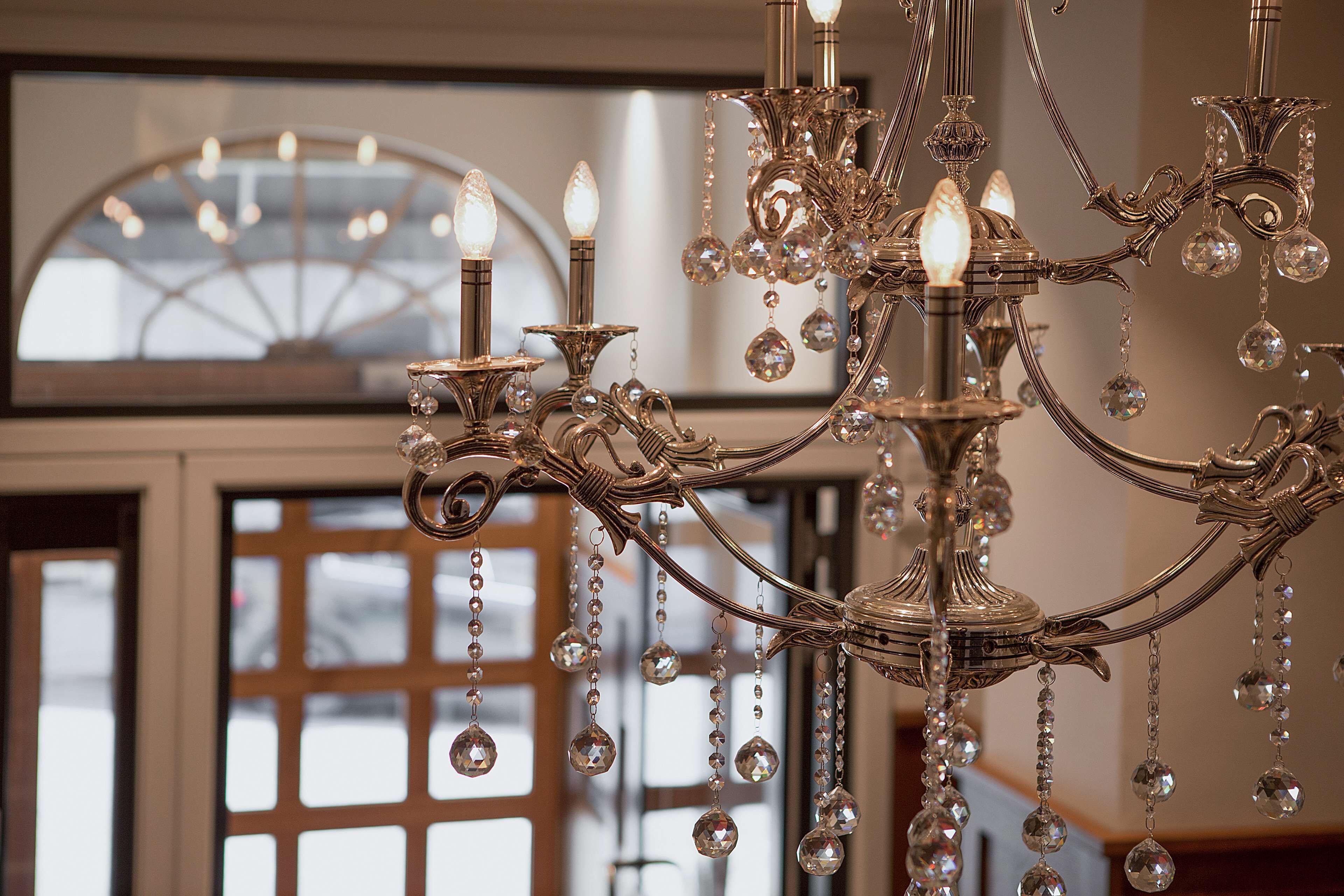 A chandelier with multiple arms and crystal decorations.