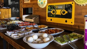 A buffet area with various food items and a Heineken bottle on the counter. - El Camino Hostel & Pub (Fethiye)