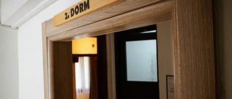A wooden door frame with a sign that reads "2. DORM".