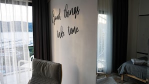 A bedroom with a bed, a chair, and a wall with a motivational quote. - El Camino Hostel & Pub (Fethiye)
