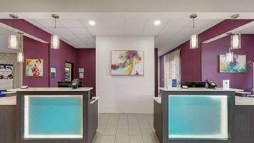 A reception area with two counters, a white ceiling, and purple walls.