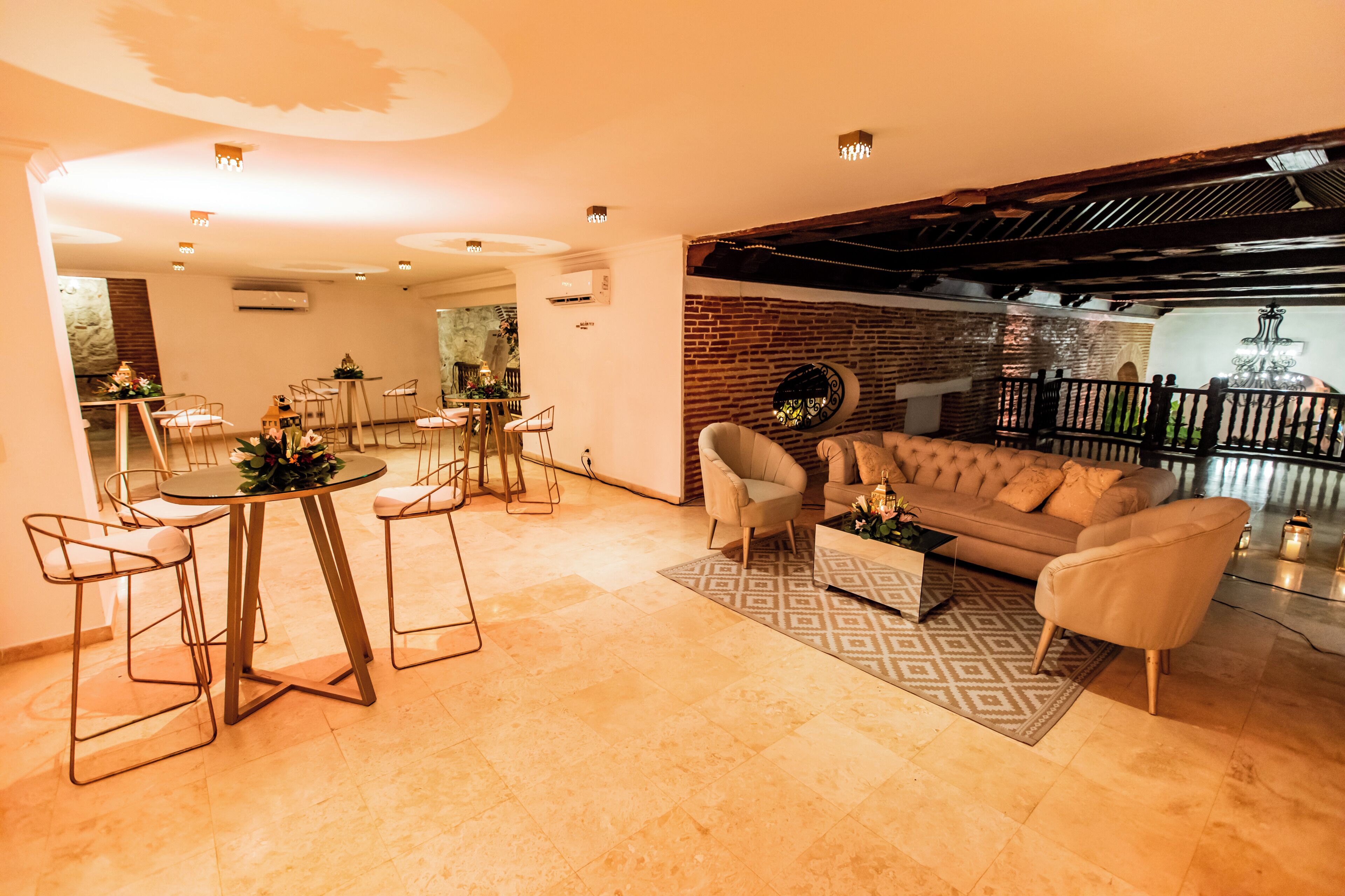 A modern living room with a sofa, chairs, a coffee table, and a dining area with a table and chairs.