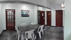 A conference room with a table and chairs, a poster on the wall, and a patterned floor. - Space (Cochabamba)