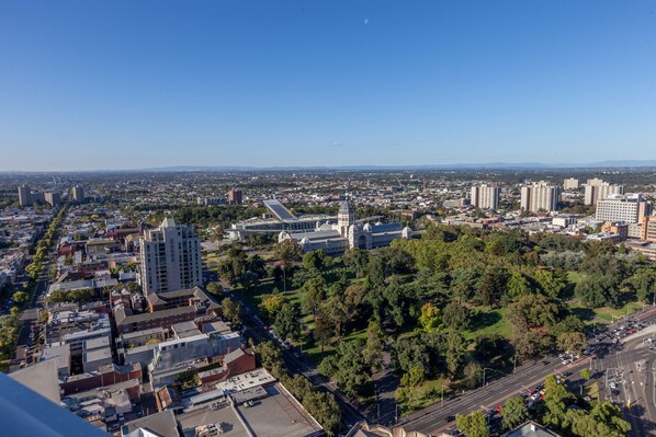 A cityscape with a prominent building with a dome, surrounded by dense urban development and greenery. - Apartment 101 (Melbourne)