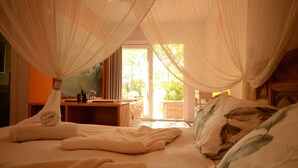 A bedroom with a canopy bed, a desk, and a view of the outdoors. - El Pao  (Jijona)