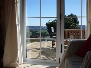 Deluxe Cottage, Garden View | Living room | Flat-screen TV, MP3 dock