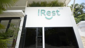 A building with a sign that reads "iRest" and the word "lounge" above it. - iRest Ao Nang Seafront (Krabi)