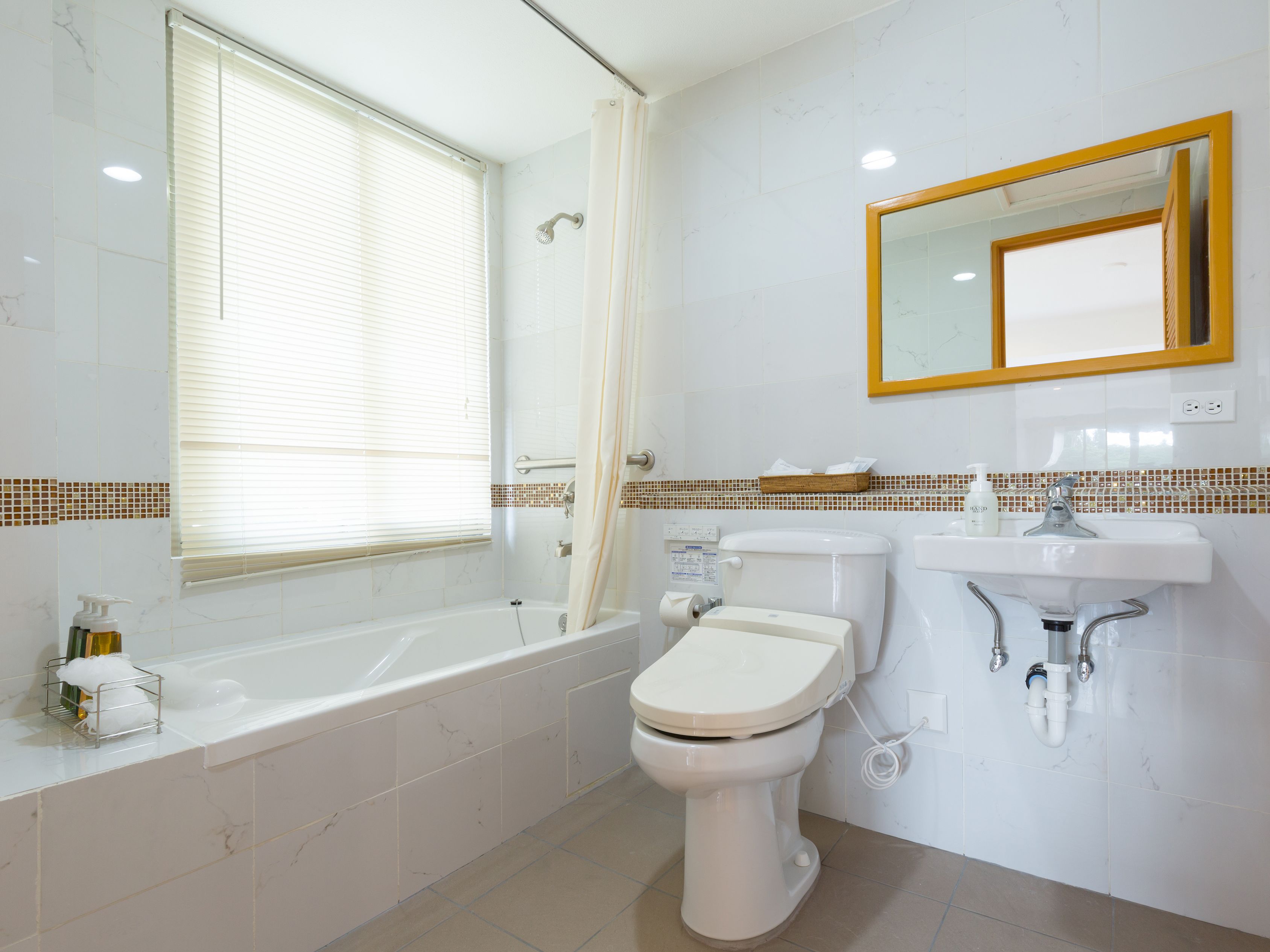 deluxe triple room (with complementary airport shuttle services) | bathroom | combined shower/bathtub, free toiletries, hair dryer, slippers