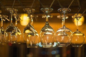 A row of empty wine glasses hanging from a ceiling. - Yangshuo Mountain Nest Boutique Hotel (Guilin)