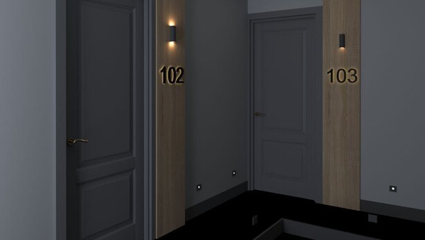 A modern hallway with two doors labeled 102 and 103, each with a small illuminated number above the door. - Pendik Marine Hotel (Istanbul)