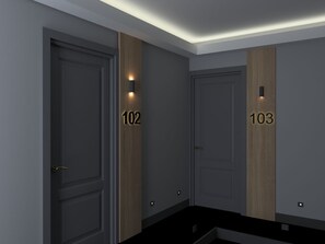 A modern hallway with two doors labeled 102 and 103, each with a small illuminated number above the door. - Pendik Marine Hotel (Istanbul)