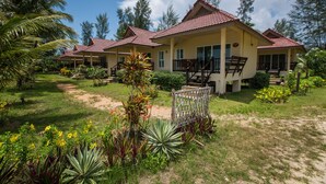 A resort with multiple buildings, each featuring a red-tiled roof and a covered porch. - Pranee Beach Bungalows (Takua Pa)