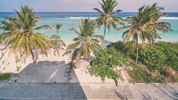 A beach with palm trees and a clear view of the ocean. - Lonuveli (Hulhumalé)