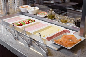 A buffet with various food items including meats, cheeses, and salads. - Hotel Kramer (Opava)