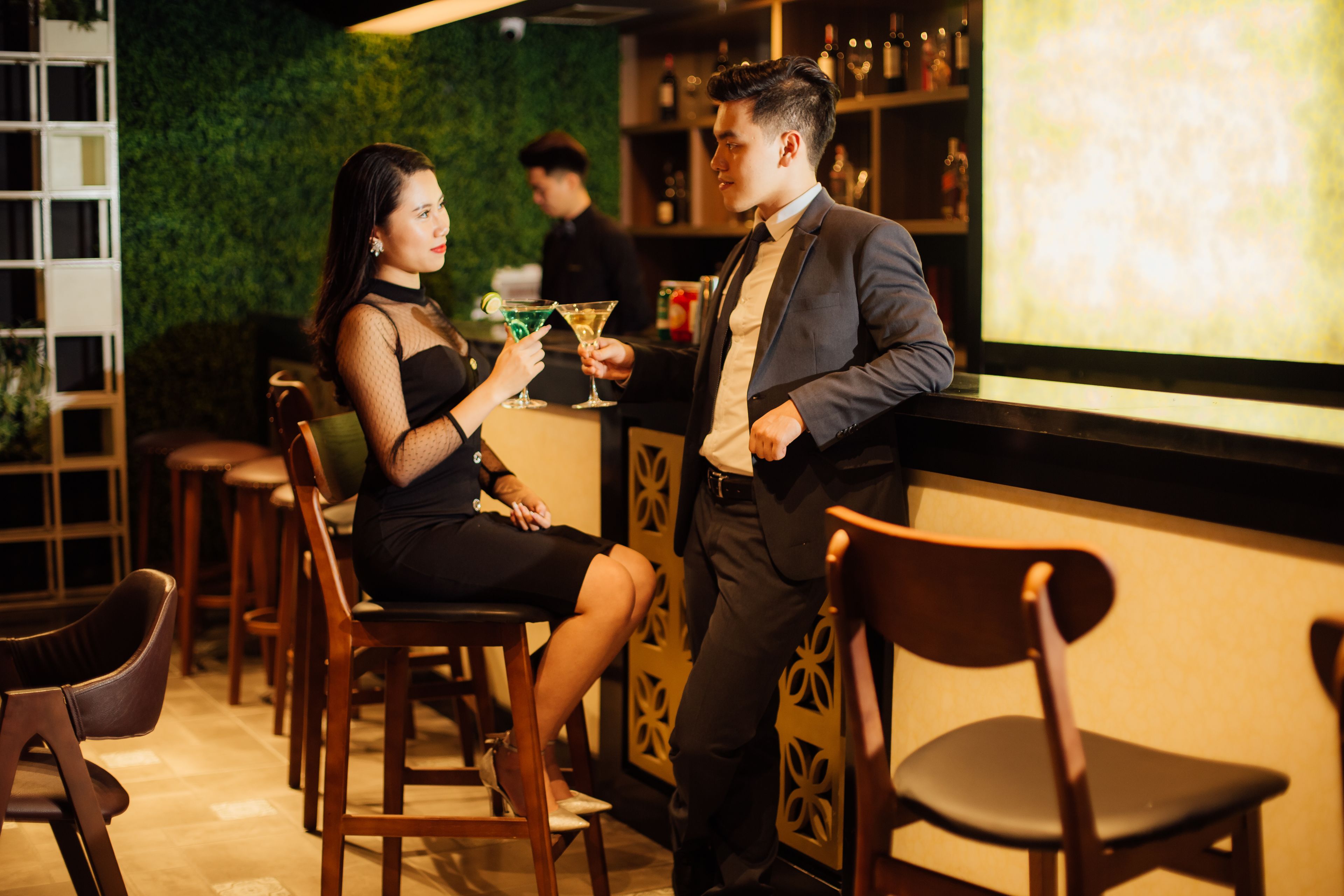 A bar area with wooden chairs and a bar counter.