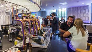 A bar area with multiple beer taps, a wine cooler, and a bar counter. - The Warwick Southport (Southport)