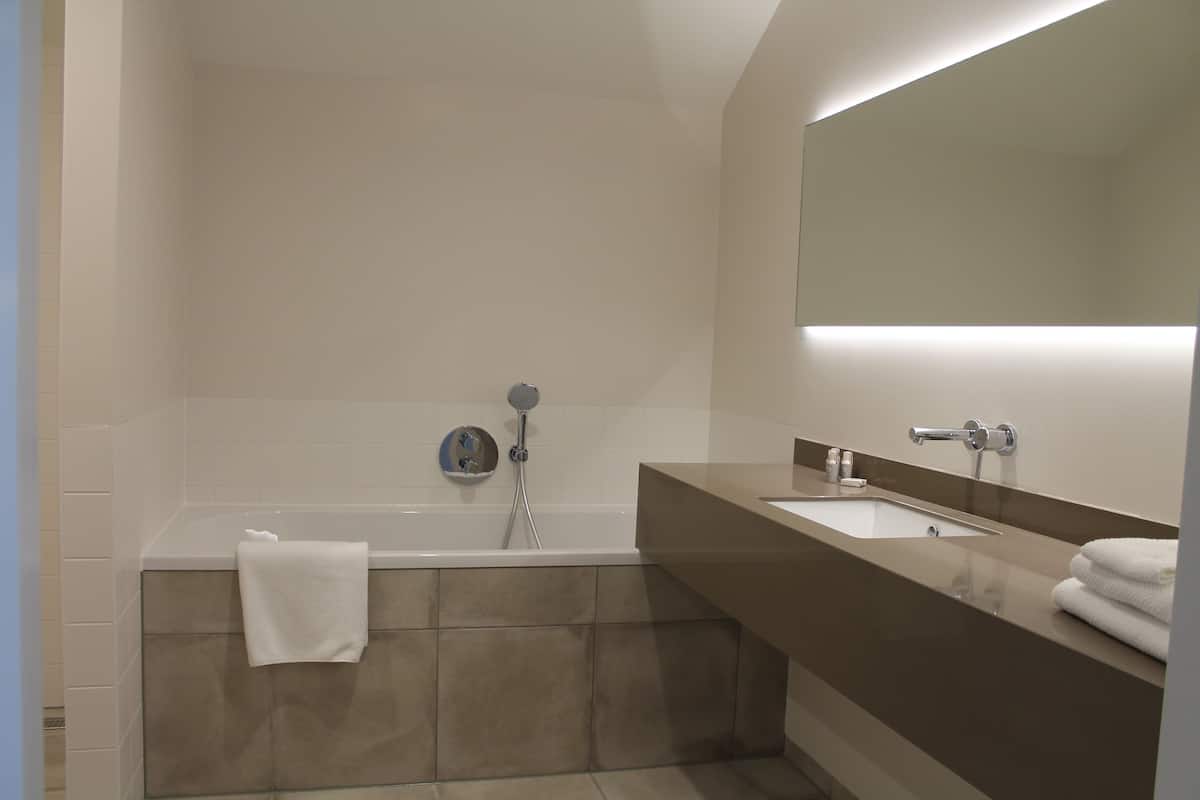 deluxe double room | bathroom | rainfall showerhead, hair dryer, towels