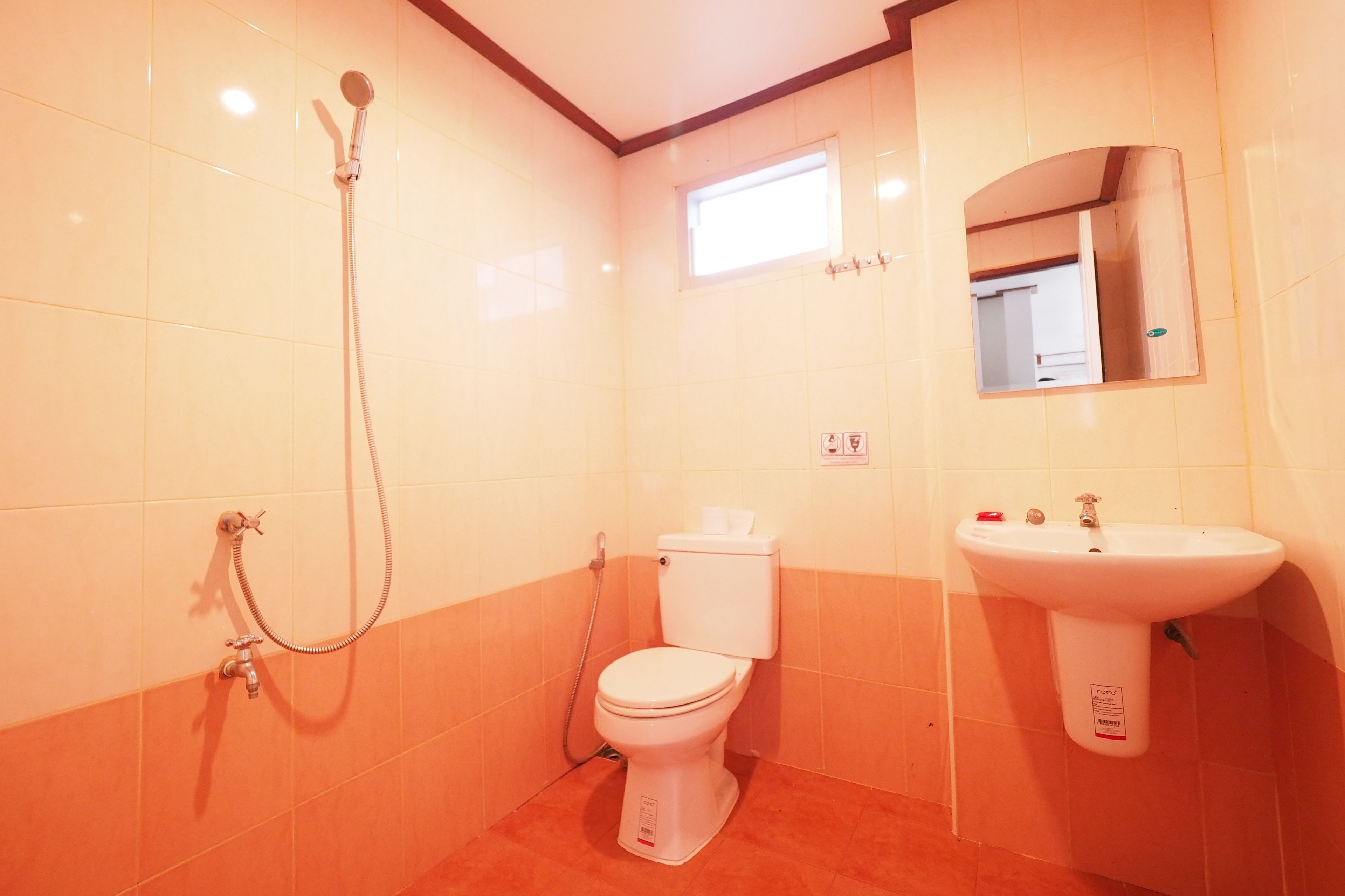 A bathroom with a toilet, a sink, and a shower.