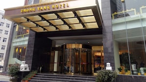 A hotel entrance with a modern design, featuring a prominent sign, a glass door entrance, and a staircase leading up to the lobby. - Wuhan Sentai Zhongyang Hotel (Wuhan)