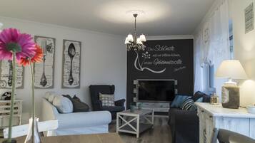 Comfort Apartment, 3 Bedrooms | Living room | Flat-screen TV