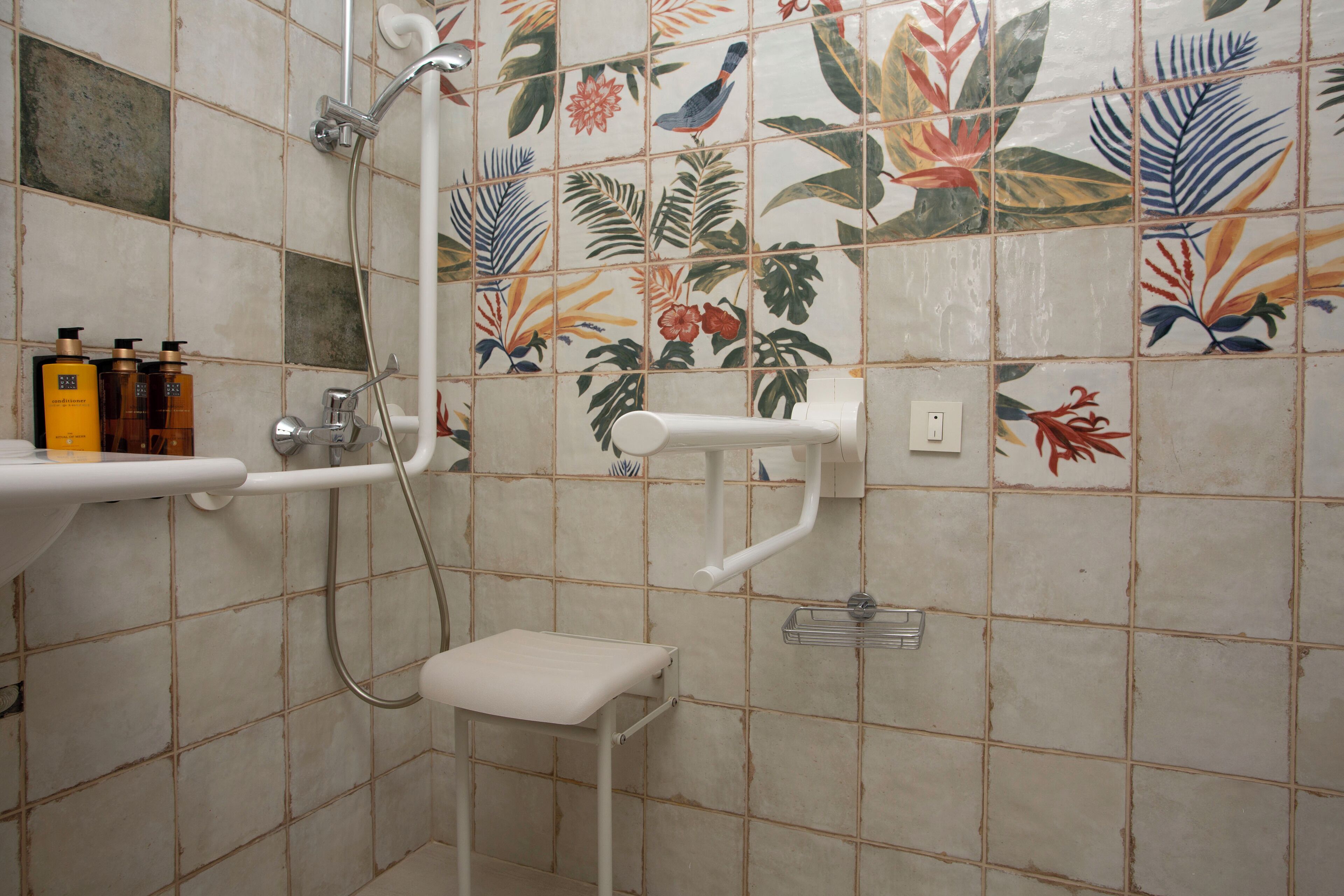 A bathroom with a shower, a toilet, and a sink.