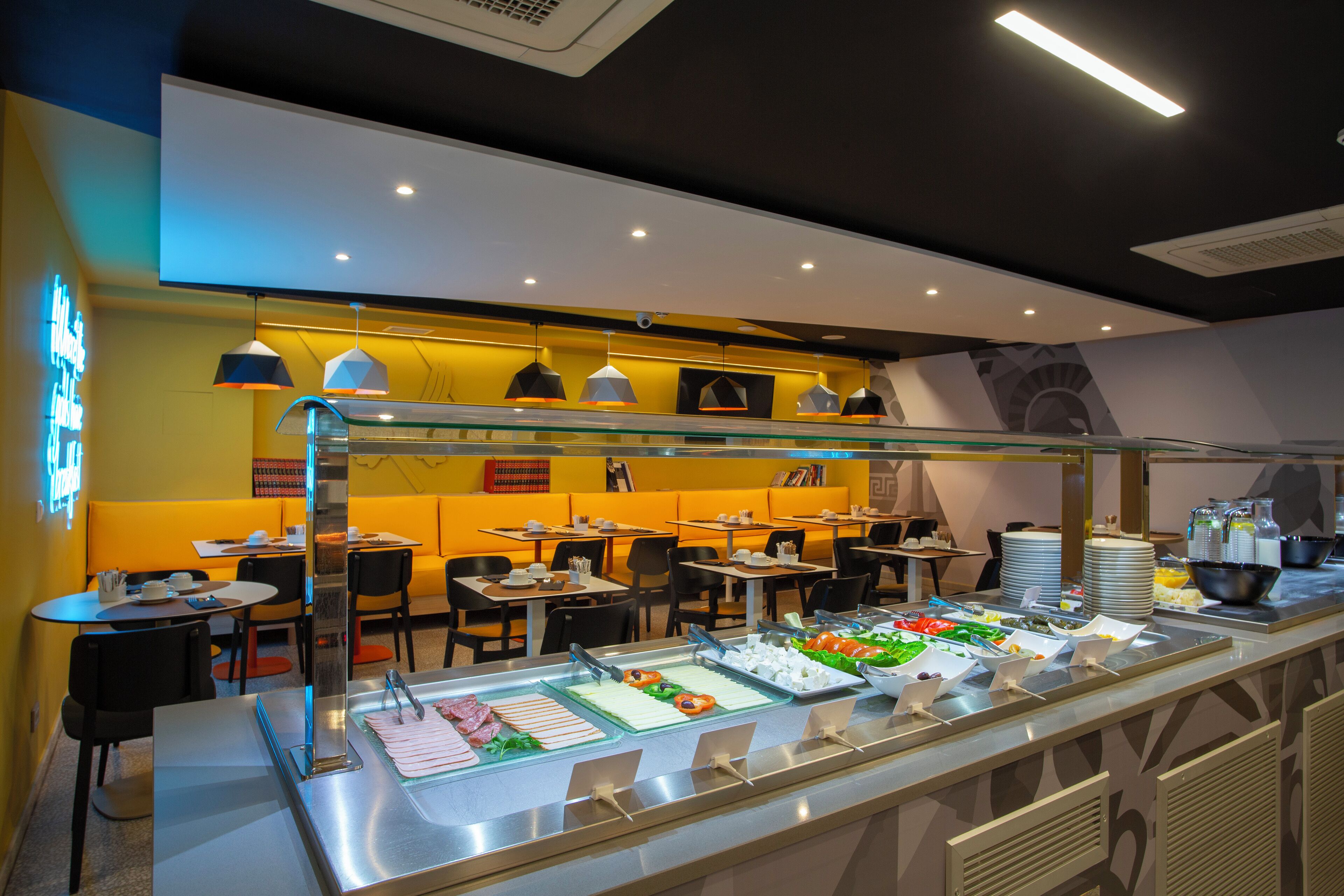 A buffet area with multiple food stations, tables, and chairs arranged for dining.