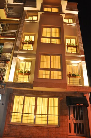 A multi-story building with large windows and balconies. - Deka Evleri (Izmir)