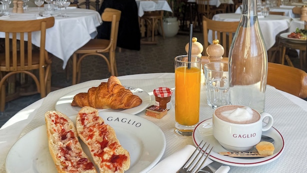 A breakfast setting with croissants, orange juice, and a coffee cup on a table. - Hotel Aparthotel AMMI Vieux Nice (Nice)