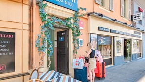 A hotel entrance with a sign reading "Ammi Vieux-Nice" and a nearby "Soleares" store. - Hotel Aparthotel AMMI Vieux Nice (Nice)