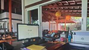 A workspace with a laptop, a notepad, and various office supplies. - The Chalet Phuket Resort (Wichit)